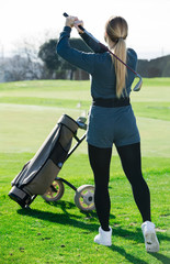 Wall Mural - woman golfer propelled ball successfully at golf course