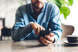 © Art_Photo - Handsome bearded hipster man use smartphone with coffee at table in cafe.Communication and technology concept