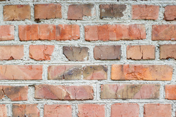 background old brick wall with remnants of plaster