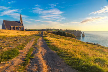 Wall Mural - Etretat, Normandy, France. cliffs, church and beautiful famous coastline during the tide