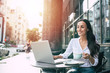 © My Ocean studio - Happy beautiful young businesswoman working on laptop in street cafe outdoor