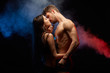 passionate couple kissing while standing face to face, isolated on black background.