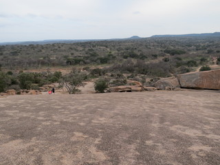 A rocky and desert like landscape at Enchanted Rock State Park in Texas.