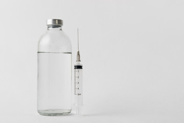 Wall Mural - medical drugs and beauty products in glass jars for injections with a syringe with a needle on a white background