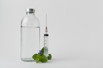 Wall Mural - medical drugs and beauty products in glass jars for injections with a syringe with a needle on a white background