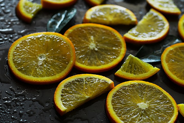 Orange citrus fruit on a stone table. Orange background.