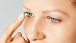 © Olesia - Young woman puts contact lens in her eye. Eyewear, eyesight and vision, eye care and health, ophthalmology and optometry concept, selective focus