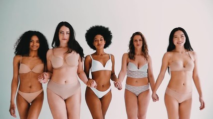 group of multi ethnic women with different kind of beauty and body, posing and having fun in a studi