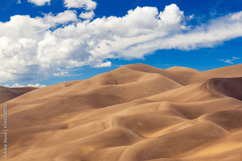 Detailed shot of the shadows on the dunes at Great Sand Dunes National Park in Colorado on a bright sunny but cloudy day - obrazy, fototapety, plakaty 