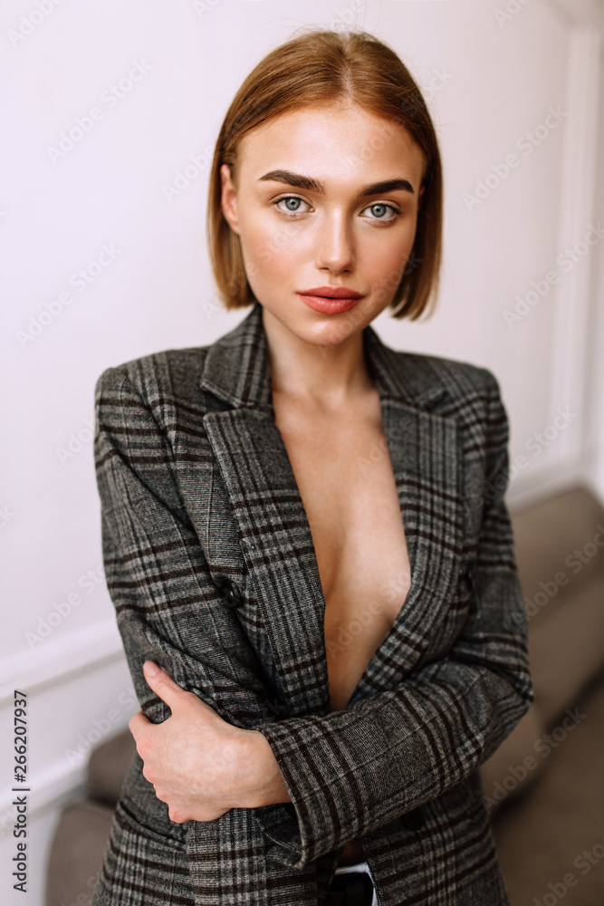 A beautiful sweet girl, dressed on a naked body jacket. Golden stylish