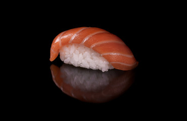 Close-up japanese food  sushi  with fresh salmon and rice on black background with reflection