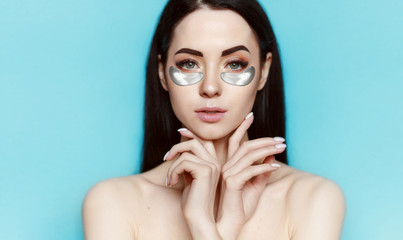 beautiful young girl with eye patches. lifting anti-wrinkle mask under eyes. woman with perfect clea