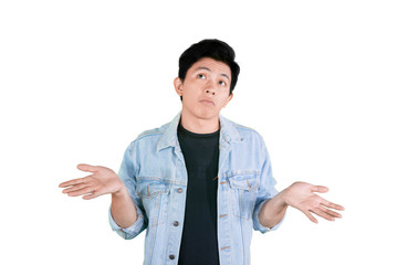 Asian man stands with poses shrug on studio