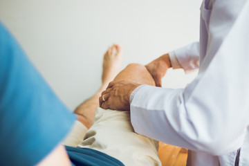 Physical therapists are using the handle to the patient knee to check for pain.