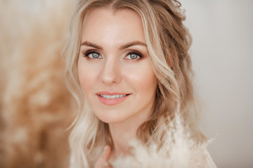 Portrait of a beautiful girl with blond hair smiling