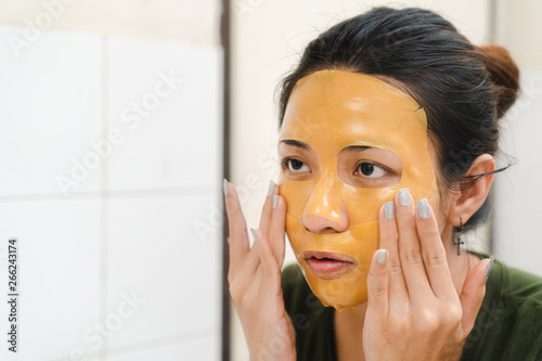 Download Young Asian Woman Take A Yellow Mask From Her Face In Bathroom Selective Focus Buy This Stock Photo And Explore Similar Images At Adobe Stock Adobe Stock PSD Mockup Templates