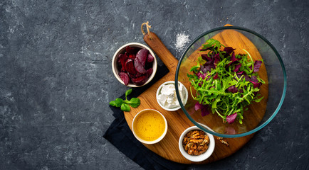 Canvas Print - Ingredients for cooking diet summer healthy food top view. preparation salad with baked beets on dark background with copy space