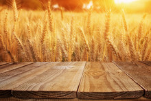 Wood Board Table In Front Of Field Of Wheat On Sunset Light. Ready For Product Display Montage