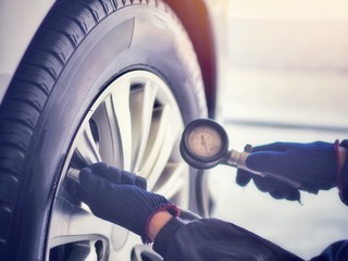 Car care, car mechanic, checking tires and filling tires. (Spot focus)