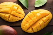 Fresh Mango Open On Wooden Background. Closeup View