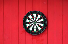 Darts Board On A Red Wooden Wall