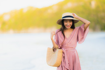 Portrait beautiful young asian woman smile happy walk on the tropical outdoor nature beach sea