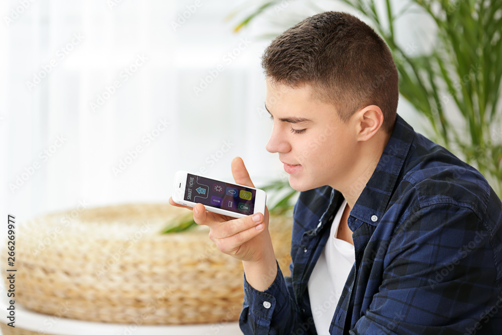 Teenage boy using application of smart home automation