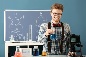 Wall Mural - Young male blogger recording video in laboratory