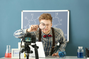 Wall Mural - Young male blogger recording video in laboratory