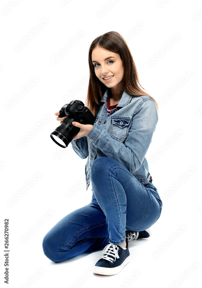 Young female photographer on white background