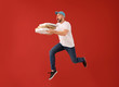 © Pixel-Shot - Jumping male courier with pizza boxes on color background