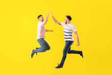 Jumping Young Men On Color Background