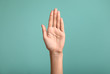 Gesturing female hand on color background
