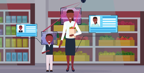Poster - mother and son holding shopping paper bag with groceries customers identification facial recognition concept security camera surveillance cctv system grocery shop interior full length horizontal