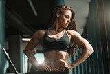 Portrait of beautiful Caucasian female bodybuilder posing with