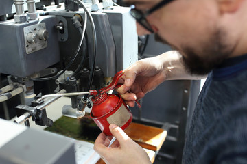 Maintenance of the printing machine. Oiling and lubricating the machine.