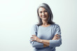 © Svyatoslav Lypynskyy - Beautiful woman with gray hair standing near the wall hands crossed