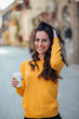 © bnenin - Portrait of a casual woman with takeout drink.