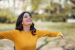 © bnenin - Positive young woman enjoying springtime in the park.