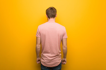 Young redhead man from behind, looking back