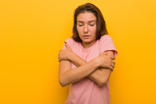 Young European Woman Isolated Over Yellow Background Going Cold Due To Low Temperature Or A Sickness.