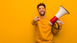 © Asier - Young man holding a megaphone cheerful and smiling