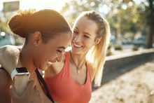 Two Friends In Sportswear Laughing After An Outdoor Workout Toge