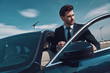 © gstockstudio - Business travel. Handsome young man in business wear entering his car while standing outdoors