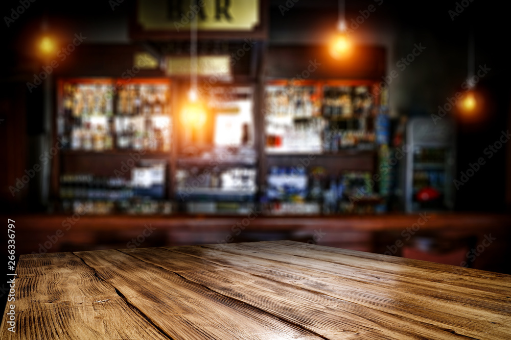 Table background of free space and blurred background of bar  - obrazy, fototapety, plakaty 