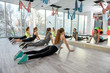 © RomanR - Group of young women doing exercises in gym