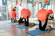 © RomanR - Group of people in gym exercising with fit ball