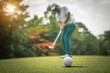 © somchai - Golfer action to win after long putting golf ball on the green golf