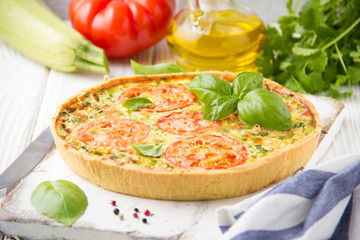 Wall Mural - Quiche with vegetables (squash, tomatoes, cheese, herbs, green onions), open tart, French cuisine, traditional pastries