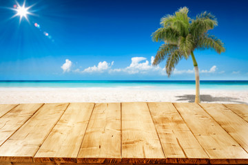 Desk of free space and summer background of ocean and beach with palm. Sunny day and blue sky. 